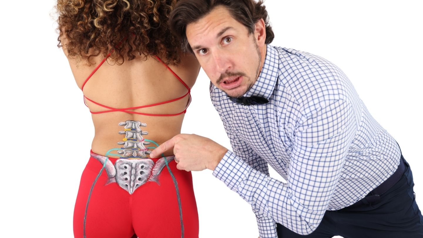 image of Dr. Mike pointing at a woman's sciatic nerve 
