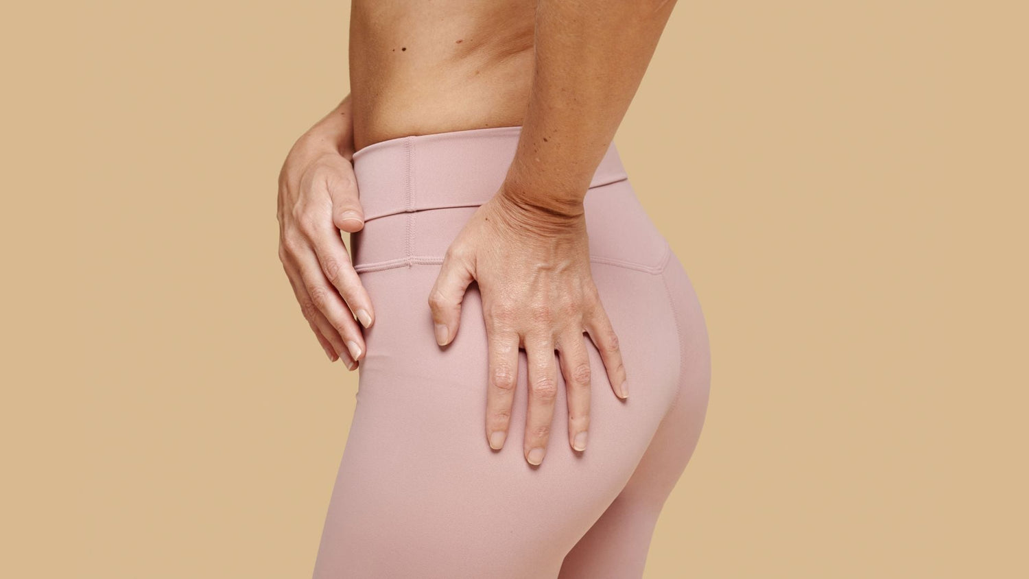 Woman indicating discomfort in tight glute muscles