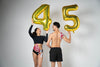 Gold foil number balloons shaped as “45”