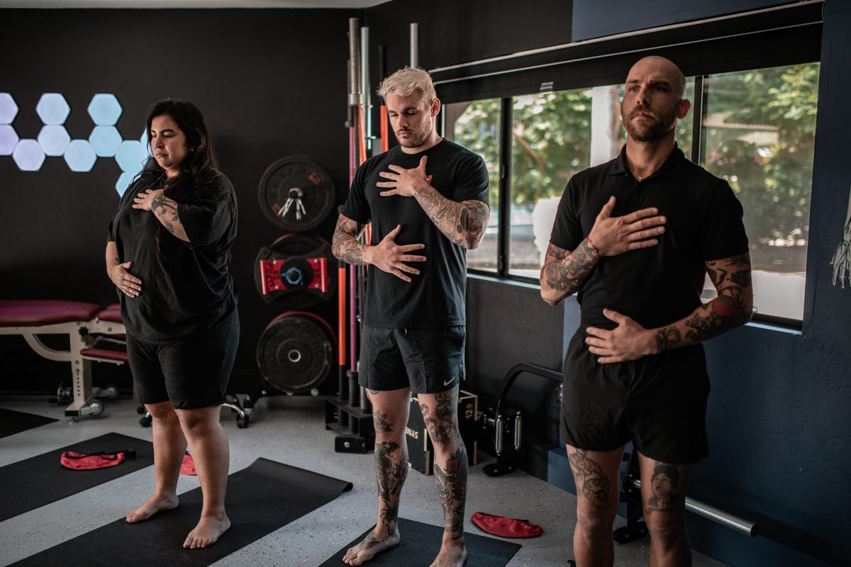 MoveU coaches and member doing a breathing exercise with hands on chest and belly